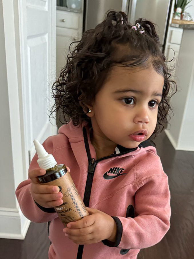A mother and her curly haired daughter together at home