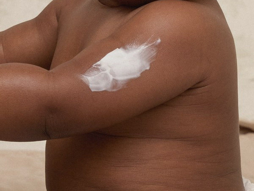 A swipe of white Body Cream on a baby's upper arm