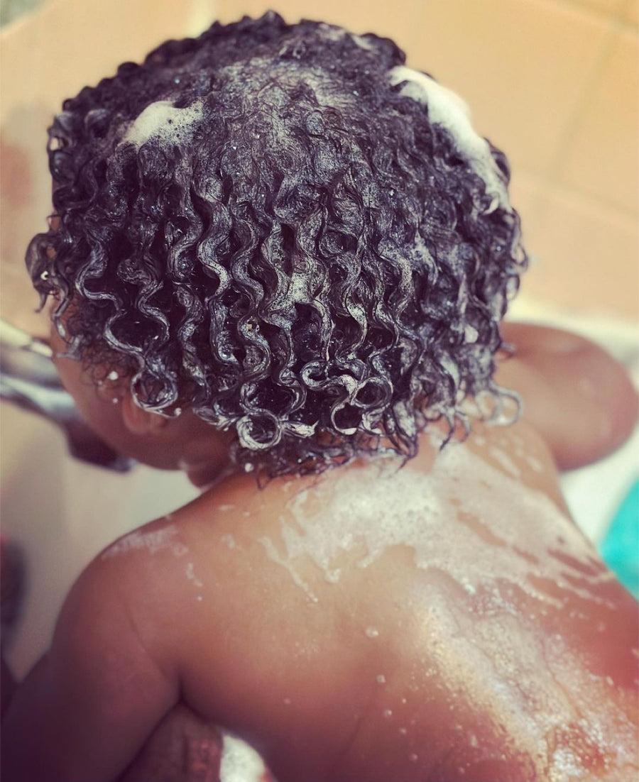 A close view of a child's defined curls after wash day