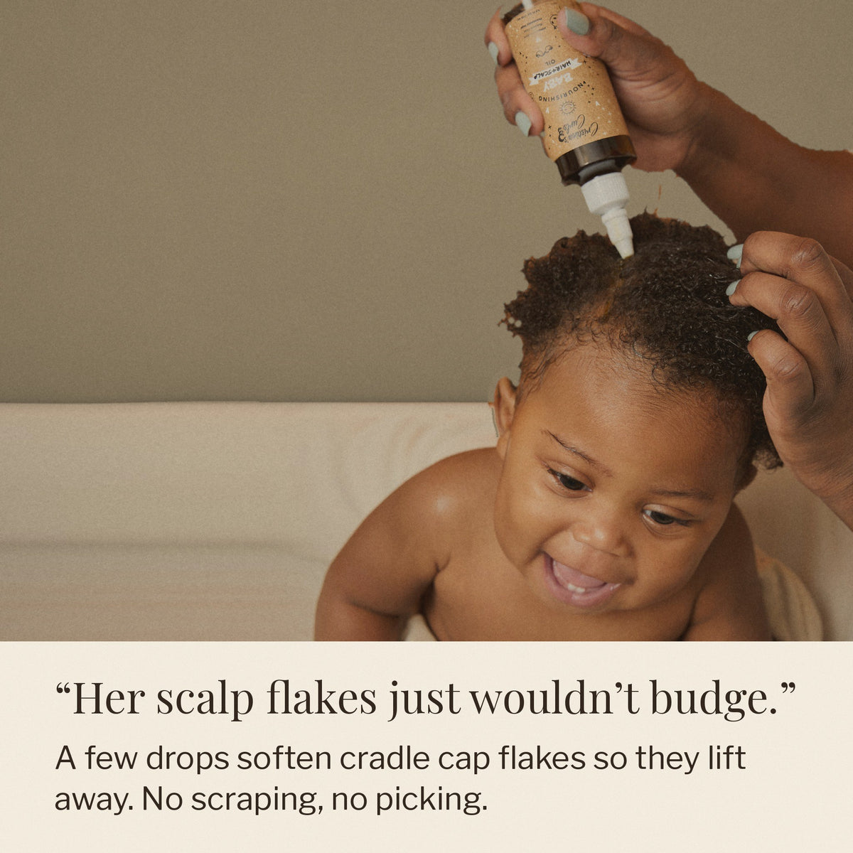 Parent working a few drops of Hair and Scalp Oil into a baby’s curls